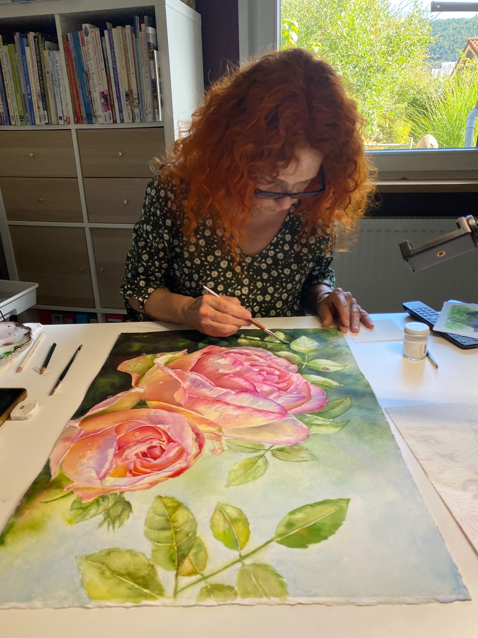 Doris Joa working in her studio on the Eden Rose watercolor painting